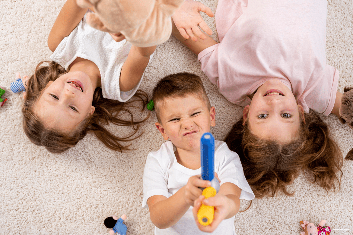 Toddlers lying on the floor and having fun